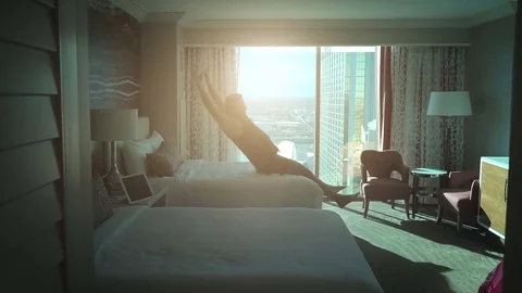 Video of man jumping on the bed in real slow motion Stock Footage
