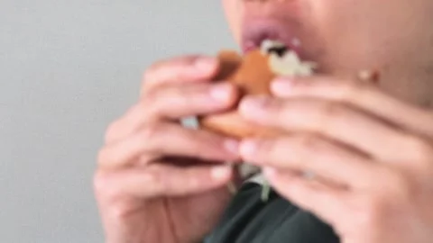 Video of a man posing after eating a hamburger Video stock 323492924