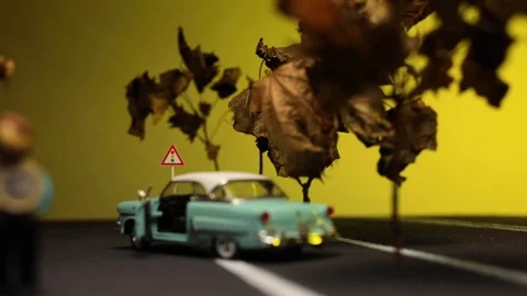 Video of a man sitting next to his broken, light blue, retro car figurine in  Stock Footage 113238623
