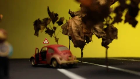 Video of a man sitting next to his broken, red, rusty,retro car figurine in t Stock Footage 113238988