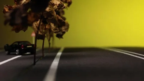 Video of a man standing next to his broken, black, new car figurine in the mi Stock Footage 133495092