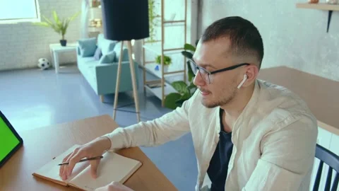 Video of a man studying from home because of the pandemic situation. Man sitting Stock Footage 168998071