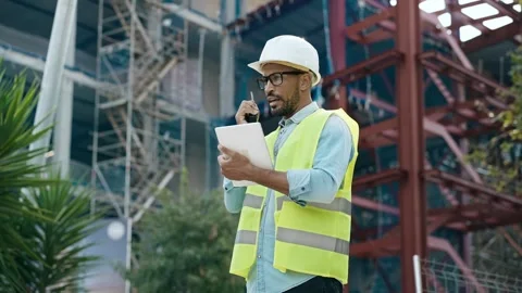 Video of man with worker's helmet talking on the walkie talkie while passin.. Stock Footage 294330381