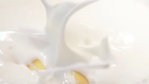Video of mango falling into yogurt in real slow motion Stock Footage 79986949