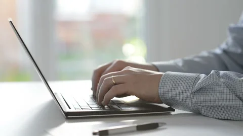 Video of man's hands working or programming with laptop at home office Stock Footage 143746384