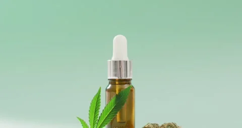 Video of marijuana leaf and buds and bottle of cbd extract on blue background Stock Footage 331245758