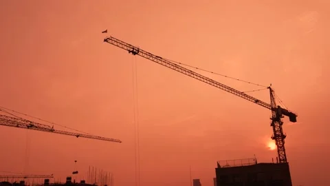 Video material of tower crane construction in urban construction site under  Stock Footage 140084574