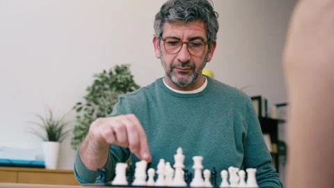 Video of mature man playing chess with a friend at home Stock Footage 340829029