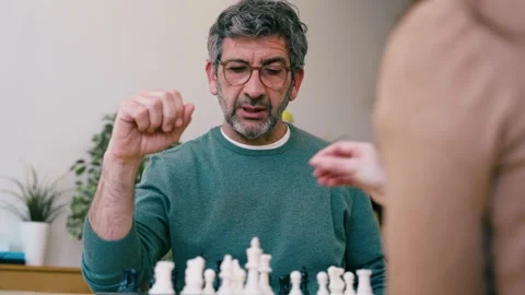 Video of mature man playing chess with a friend at home Stock Footage 340829184