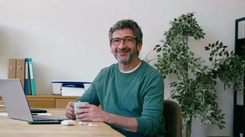 Video of mature man taking a break of work while drinking a cup of coffee a.. Stock Footage 340829271