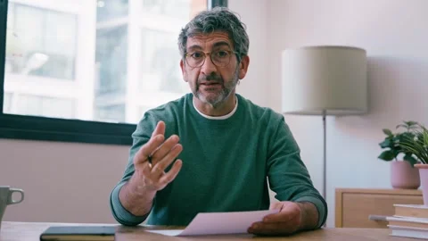 Video of mature man working while doing a videocall at the office Stock Footage 340829279