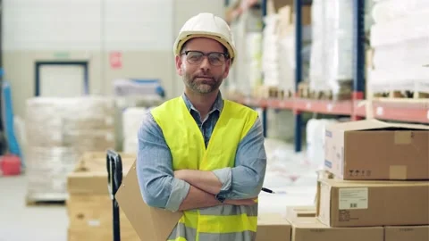 Video of mature worker looking at camera while passing list of material that  Stock Footage 172413587