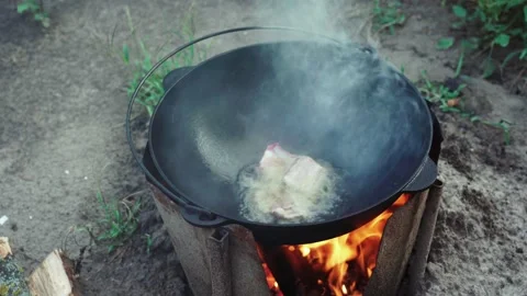 Video of meat are fried in cauldron outdoor Stock Footage 160438334