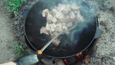 Video of meat are fried in cauldron outdoor Stock Footage 160452275