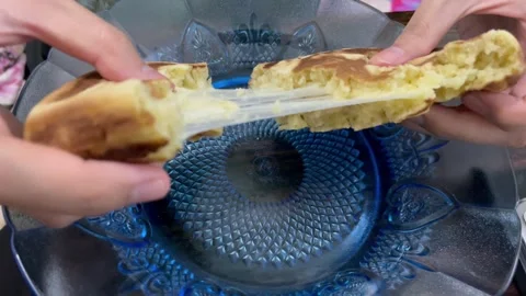 Video melted mozzarella cheese pull from korean hotteok pancake Stock Footage 322590041