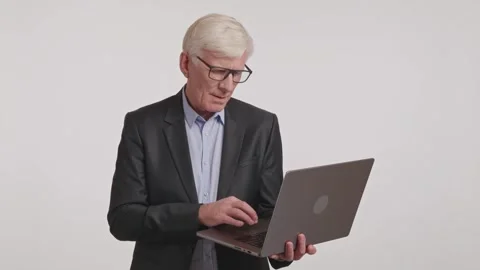 Video of men in suits using laptops in professional setting Stock Footage 266921855