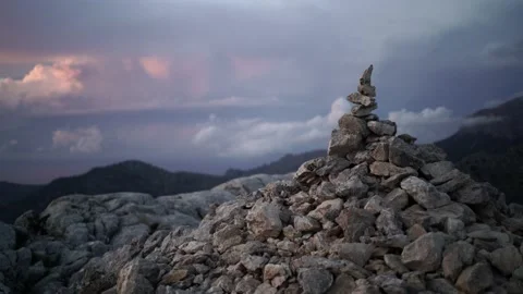 Video of a milestone in the top of a mountain during cloudy sunset Video stock 146591969