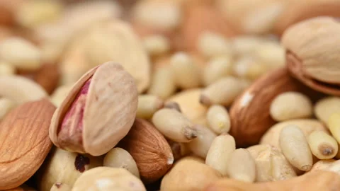 Video of a mix of pine nuts, cashews, hazelnuts, almonds, and pistachios Stock Footage 327963408