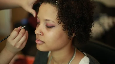 Video of a model having makeup applied by a makeup artist before a photoshoot. Stock-Footage 89904087