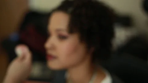 Video of a model having makeup applied by a makeup artist before a photoshoot. Stock Footage 89905718