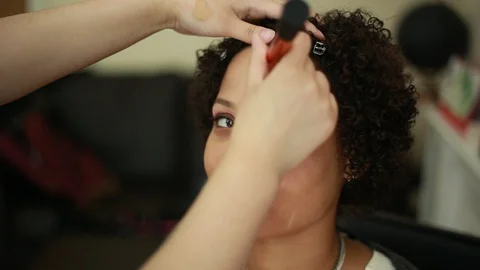 Video of a model having makeup applied by a makeup artist before a photoshoot. Stock Footage 89923627