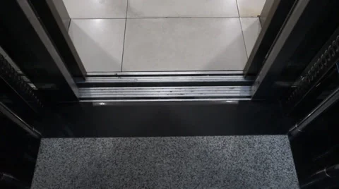 Video of modern elevator door closing before moving up several floors with tiles Stock Footage 37628999