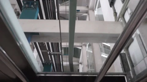 Video of modern elevator moving down several floors with transparent glass and d Stock Footage 37628895