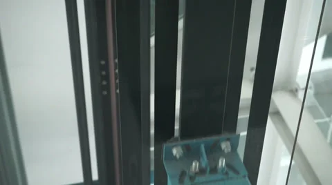 Video of modern elevator moving down several floors with transparent glass, nuts Video stock 37628988