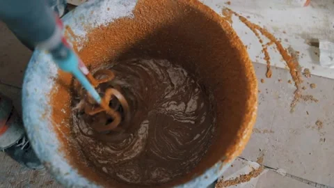 Video in motion with a worker mixing colored polyurethane mortar with epoxy r Stock Footage 161496775