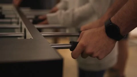 Video of multiple individuals playing the game of table football known as Stock Footage 203708410