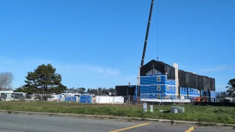 Video of multistory construction with black tarp, blue insulation Stock Footage 328692023