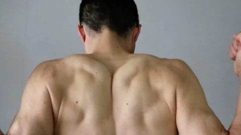 Video of a naked man posing from behind Stock Footage 324541502