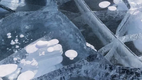 Video of natural winter ice texture with white bubbles and cracks in blue ice Stock Footage 305444112