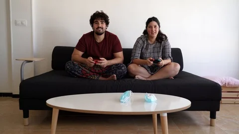 Video of a new normal after the covid 19 sanitary crisis, a couple play video 스톡 동영상 129526429