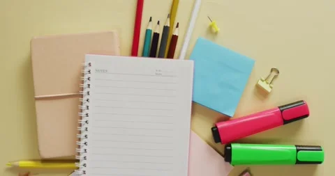 Video of notebook with copy space and school equipment on yellow background Stock Footage 331245668