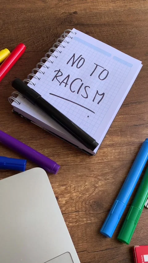 Video of a notebook with the phrase "no to racism" on a table. Stock Footage 262453176