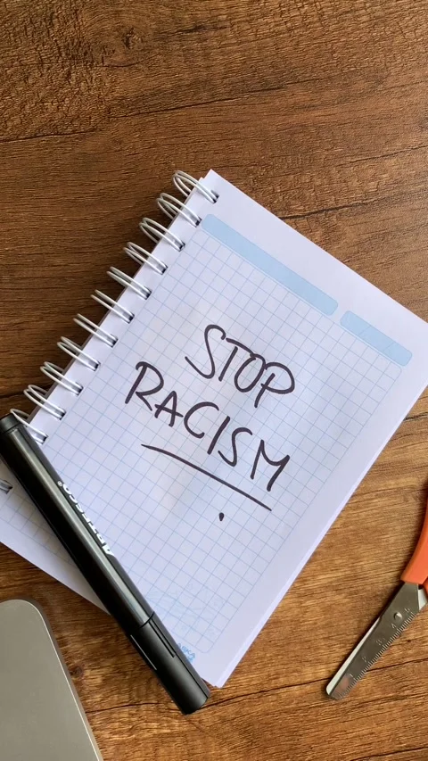 Video of a notebook with the phrase "no to racism" on a table. Stock Footage 262453181