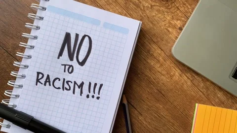 Video of a notebook with the phrase "no to racism" on a table. Stock Footage 262453370