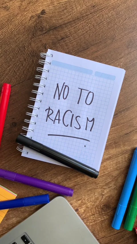 Video of a notebook with the phrase "no to racism" on a table. Stock Footage 262453676