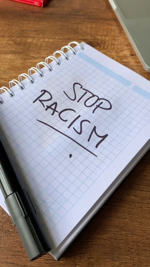 Video of notebook with phrase "stop racism" on a table. Stock Footage 262453228