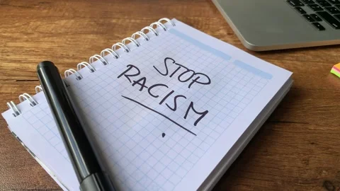 Video of notebook with phrase "stop racism" on a table. Stock Footage 262453238