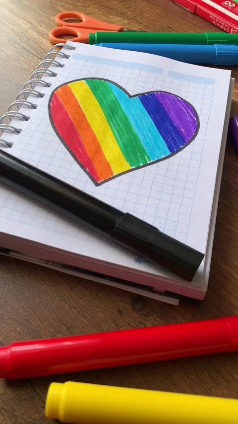 Video of notebook on wooden table with hand drawn LGBTQ+ heart. Stock Footage 262452278