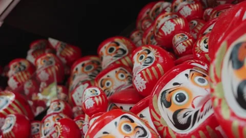 A video of numerous red Daruma dolls displayed at Katsuoji Temple in Osaka Stock Footage 344279724