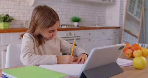 Video online class using web camera, cute small preschooler child waves, at desk Stock Footage 321812543