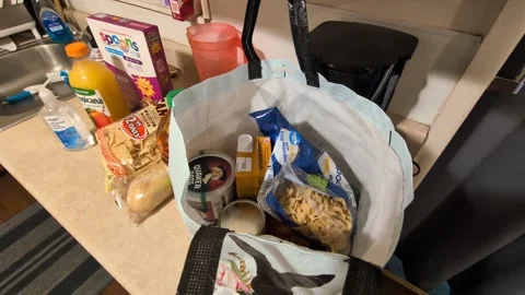 A video of an open reusable grocery bag filled with pantry food items Stock Footage 346257949