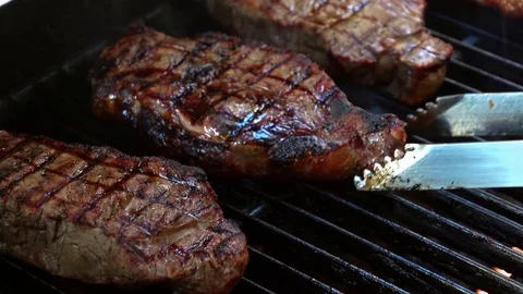 Video of opening the grill with steaks in real slow motion Stock Footage 78645812