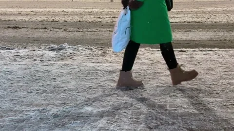 The video opens with a panoramic view of an illuminated bus stop at dusk Stock Footage 328405289