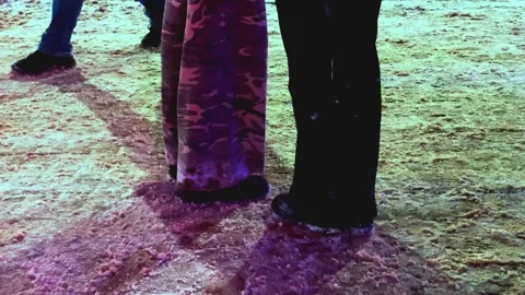 The video opens with a panoramic view of an illuminated bus stop at dusk Stock Footage 328405434