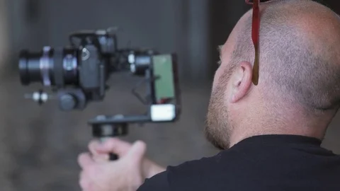 Video operator filming with steadycamera Stock-Footage 84036665