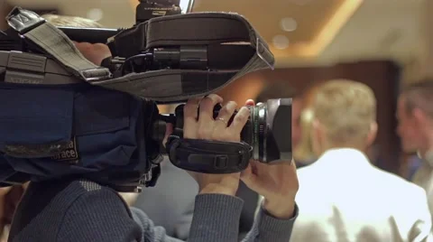 Video operator holds camera and shoots interview Stock Footage 58798226